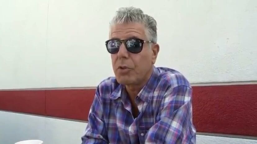 A man in sunglasses sitting at a table.